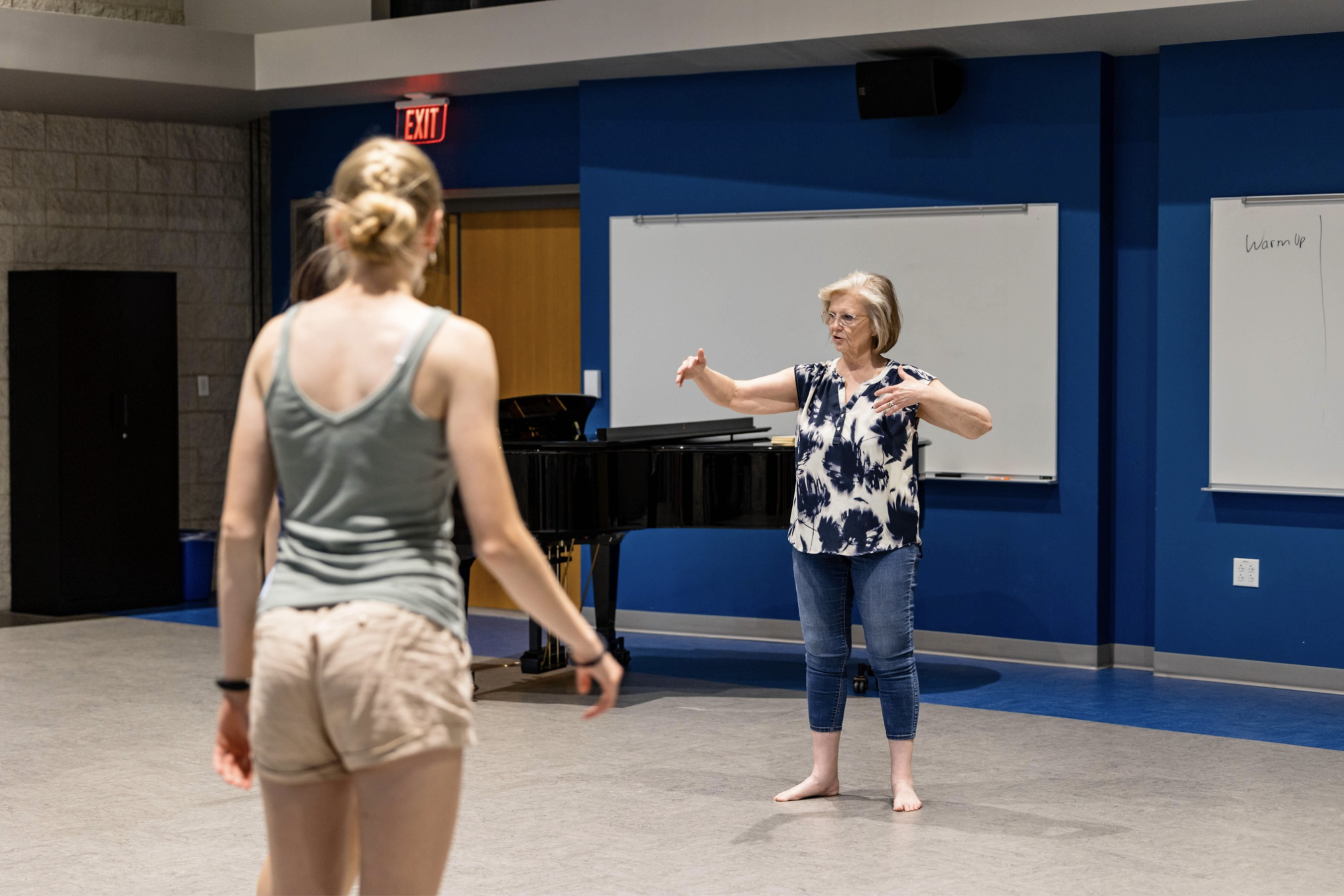 professor teaching a student to do vocal warm up drills